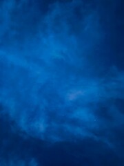 The sky on the background of sunset, colorful clouds. An abstract composition in nature with natural blue, pink, purple shades of the horizon. The natural environment.