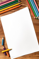 Blank paper surrounded by colored pencils on a wooden surface.