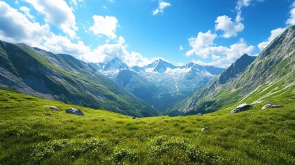 Obraz premium Breathtaking view of snow-capped mountains and lush green valleys under a vibrant blue sky.