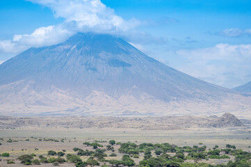 Fototapeta premium Ol Doinyo Lengai volcano that has an abundant amount of clouds, Tanzania