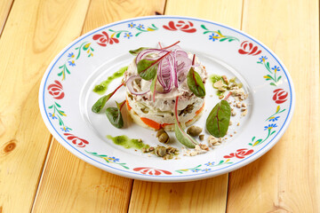 russian salad on the wooden background