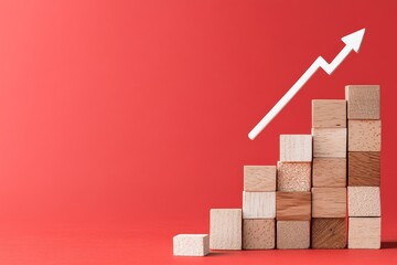 A stack of wooden blocks forms a staircase-like structure, representing growth, with an arrow pointing upwards on a plain red background.