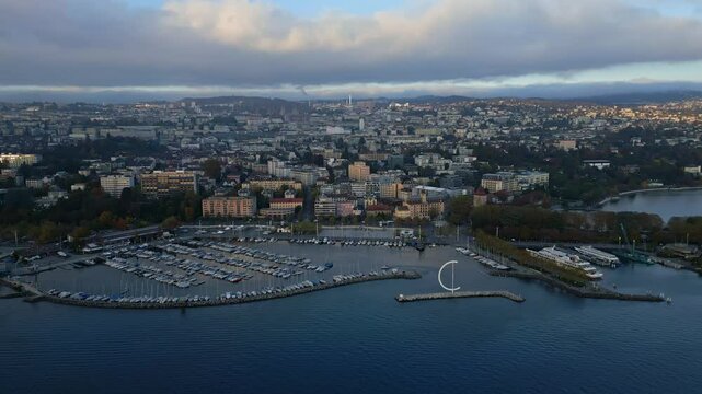 Dolly in drone shot over Ouchy Port in Lausanne at sunset in Switzerland