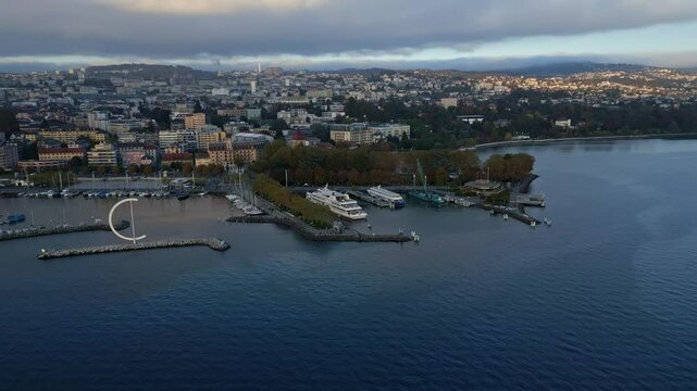 Orbit drone shot of Eole Sculpture at Ouchy Port at sunset in Lausanne Switzerland