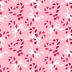 Seamless pattern with Christmas candy canes and bows on pink background. Romantic background design for fabric, wrapping paper, textile, wallpaper