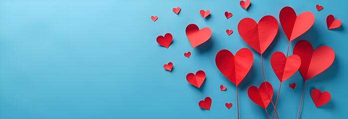 Background design for Valentine's Day.  Valentine's Day card with paper flying hearts a blue background. Symbols of love in the shape of a heart for the design of greeting cards