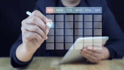 Businessman using pen to writing circle mark on virtual calendar agenda of booking and appointment meeting concept.