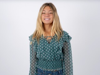 caucasian teen girl wearing green dress over white 
 with nice beaming smile pleased expression. Positive emotions concept