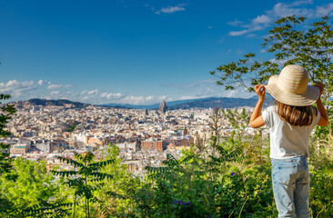 Scenic cityscape of Barcelona from an elevated perspective, with a little girl in a straw hat, blending natural and urban beauty