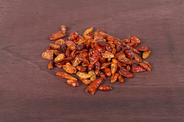 Bird's eye chilies on a dark wooden background