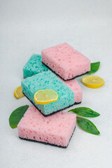 Various sponges for washing dishes. Organic cleaning concept, lemon freshness. Stone background