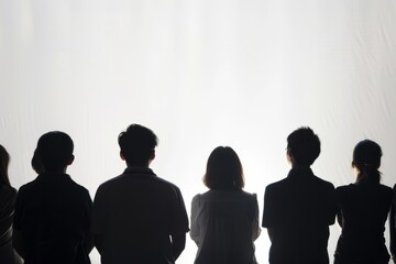 Obraz premium Capture the silhouettes of several individuals from the back with a clean white backdrop