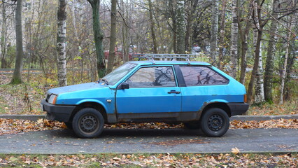 An old rusty light blue car is parked on the road., Iskrovsky Prospekt, Saint Petersburg, Russia, November 07, 2024