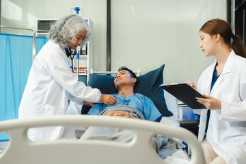 doctor talking to male patient at bed in hospital.