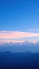 Obraz premium view of a mountain range with a few clouds in the sky