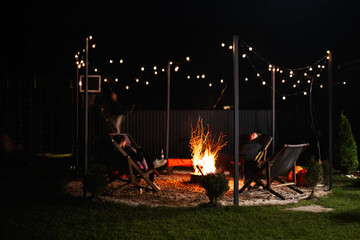Cozy outdoor evening with fire pit and string lights
