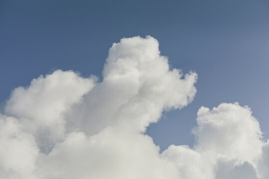 White cumulus clouds against blue sky
