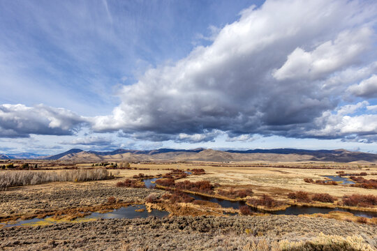 Clouds over wetlands and hills in distance at Silver Creek Preserve