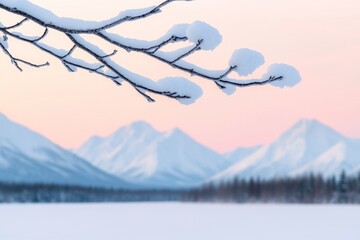 A serene winter landscape featuring snow-covered branches and mountains, casting a peaceful atmosphere at dawn.