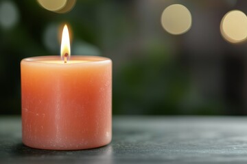 A softly glowing candle on a dark surface, with blurred green and yellow lights in the background, creating a warm, tranquil atmosphere.