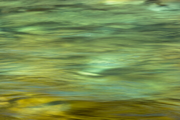 Blurred green surface of shallow river