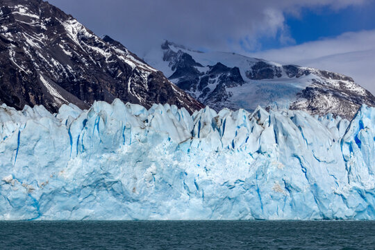 Argentina, Santa Cruz, El Calafate, Perito Moreno glacier ice formations with water in foreground