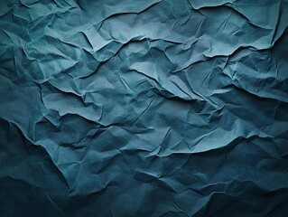 Fototapeta premium Crumpled blue-gray paper background with subtle gradient shading and soft wrinkles, adding depth and texture for a professional feel