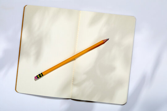 USA, New York State, New York City, Pencil on open note pad on white background