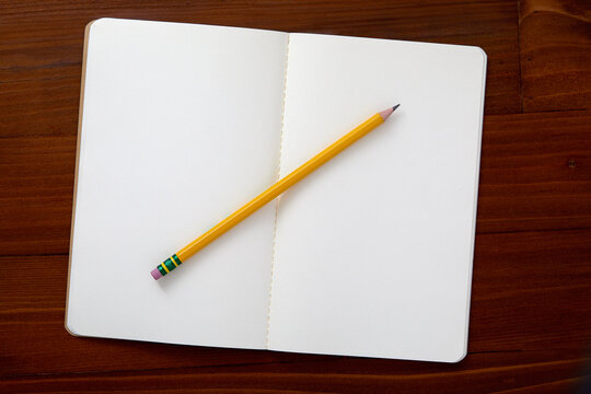 USA, New York State, New York City, Pencil on open note pad on brown background