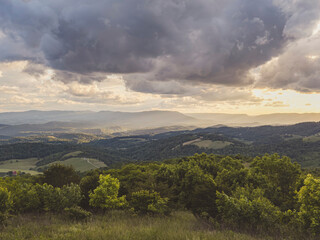 USA, Virginia, Newport, Storm clouds over hilly landscape at sunset
