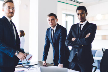 Diverse group of confident colleagues preparing business project in office