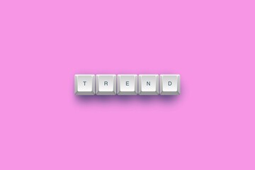 Keys spelling 'trend' on pink background