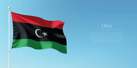 Waving Flag of Libya Against Clear Blue Sky Copyspace
