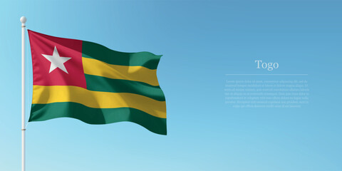 Waving Flag of Togo Against Clear Blue Sky Copyspace