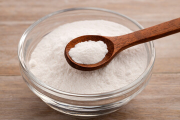 Baking soda - Crystalline solid compound in spoon and bowl.