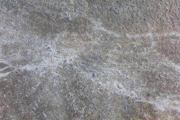 A grey concrete surface with a few small cracks
