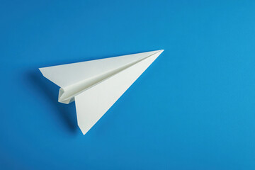 paper airplane on blue background isolated