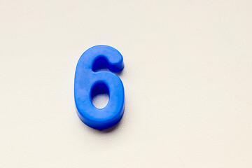 Number 6 .Top view. Copy space. Numerical digit.Banner. number 6 in blue on a white background