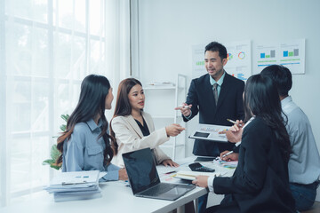 Business Meeting: A diverse team of professionals engaged in a productive meeting, brainstorming ideas and collaborating on a project, fostering a positive and dynamic work environment.
