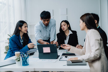 Collaborative Brainstorming: A diverse team of professionals engaged in a lively discussion around a table, showcasing the power of collaboration and innovation in the modern workplace.  