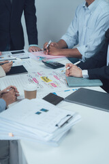 Collaborative Brainstorming: A close-up shot of a diverse team of professionals engaged in an intense brainstorming session, their hands scribbling notes and ideas on a whiteboard.