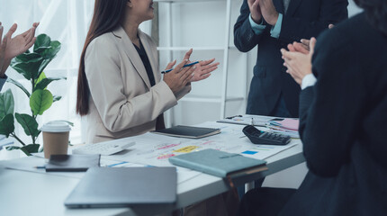 Team Applause: A group of business professionals applauds in a modern office setting, showcasing collaboration, recognition, and a positive work environment.  