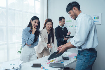 Team Collaboration: A diverse team of business professionals gather around a table, engaging in a lively discussion and reviewing documents. This photo represents the essence of collaboration.