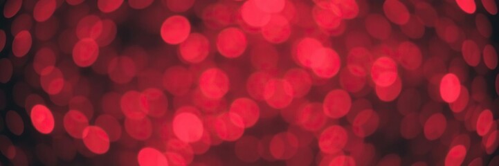 Fototapeta premium Red bokeh snowflakes background with defocused lights and glittering effect, snowflakes