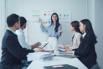 Businesswoman Leading a Team Meeting: Confident businesswoman giving a presentation to her diverse team, showcasing data charts and engaging in lively discussion.