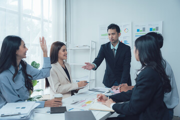 Business Meeting: A diverse team of professionals engage in an animated discussion during a productive meeting, fostering collaboration and generating innovative ideas.  