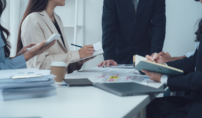 Focused Business Team Meeting:  A diverse group of professionals collaborates intensely during a...