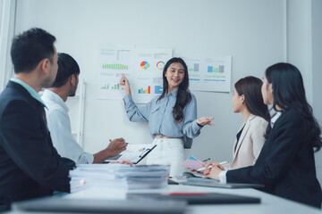 Fototapeta premium Confident Presentation: Businesswoman Leading Team Meeting 