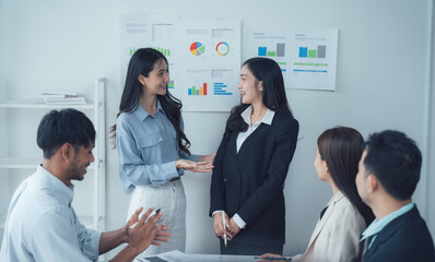 Collaborative Discussion:  A diverse team of business professionals actively engages in a lively discussion, showcasing teamwork and collaboration during a brainstorming session.