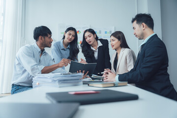 Teamwork Makes the Dream Work: A diverse group of business professionals collaborate around a table, engaged in a lively discussion, showcasing the power of teamwork and shared goals.  